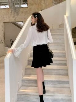 White Bell Sleeve Blouse With Black Bow Tie 33 White Bell Sleeve Blouse With Black Bow Tie -Amped Apparel IU Oversized Bow Tie And Laced Bell Cuffs Shirt 00002 600x808 1