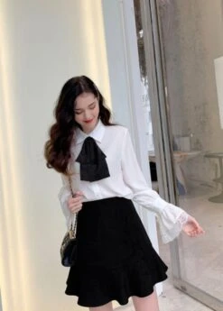 White Bell Sleeve Blouse With Black Bow Tie 29 White Bell Sleeve Blouse With Black Bow Tie -Amped Apparel IU Oversized Bow Tie And Laced Bell Cuffs Shirt 00007 600x837 1